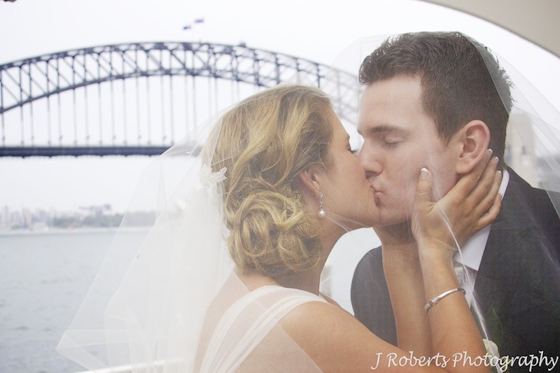 Couple kissing under brides veil - wedding photography sydney